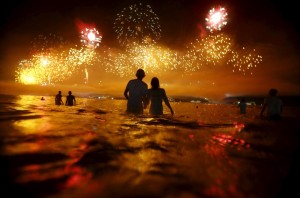 Una pareja observa los hermosos fuegos pirotecnicos a orilla del mar en Copacabana, Rio de Janeiro, durante la celebration de Año Nuevo. People watch as fireworks explode over Copacabana beach during New Year celebrations in Rio de Janeiro, Brazil, January 1, 2016. REUTERS/Ricardo Moraes