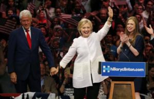 Hillary Clinton waves as she stands onstage with her husband and her daughter after speaking during her California primary night rally held in Brooklyn. REUTERS/Lucas Jackson