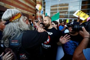 A man faces off with protesters during a rally against Donald Trump in Phoenix, Arizona. REUTERS/Nancy Wiechec